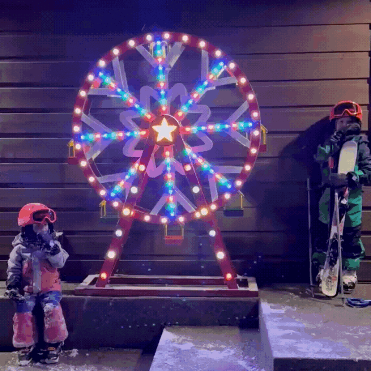 Animated GIF of Mr. Christmas Oversized Ferris Wheel spinning with dazzling light effects.