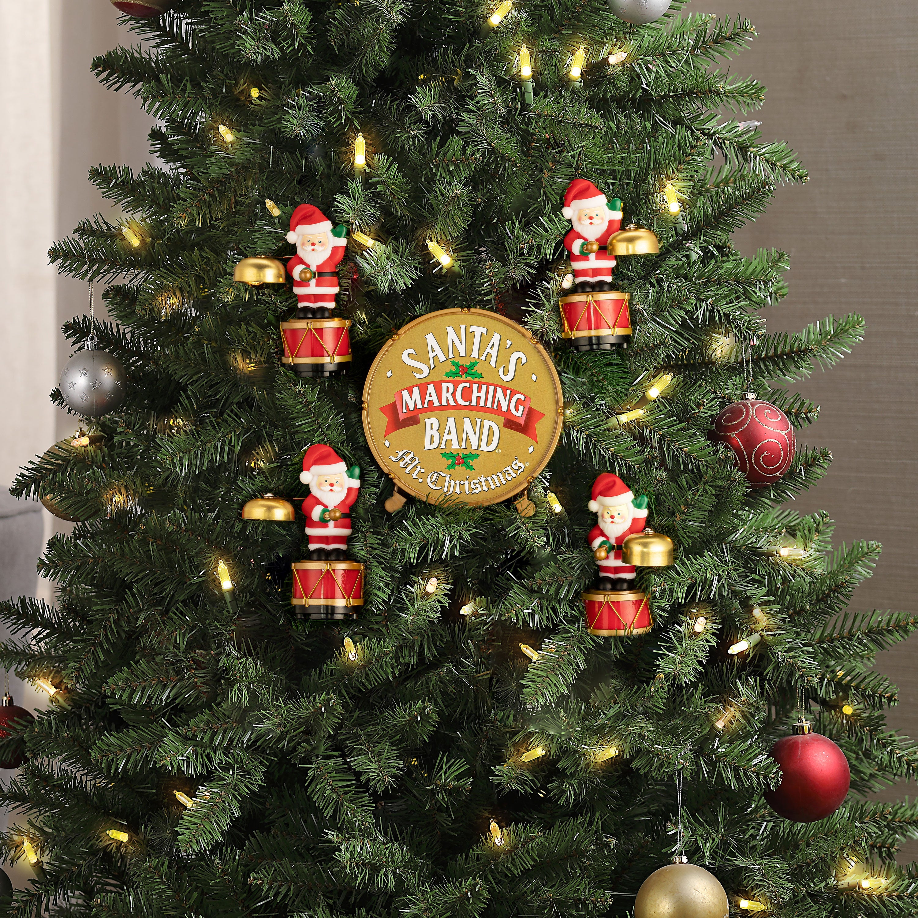 Mr. Christmas Animated Santa's Marching Band hung on a decorated Christmas tree