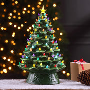 Mr. Christmas 18" Nostalgic Ceramic Tree display on a tabletop with snow in a festive background