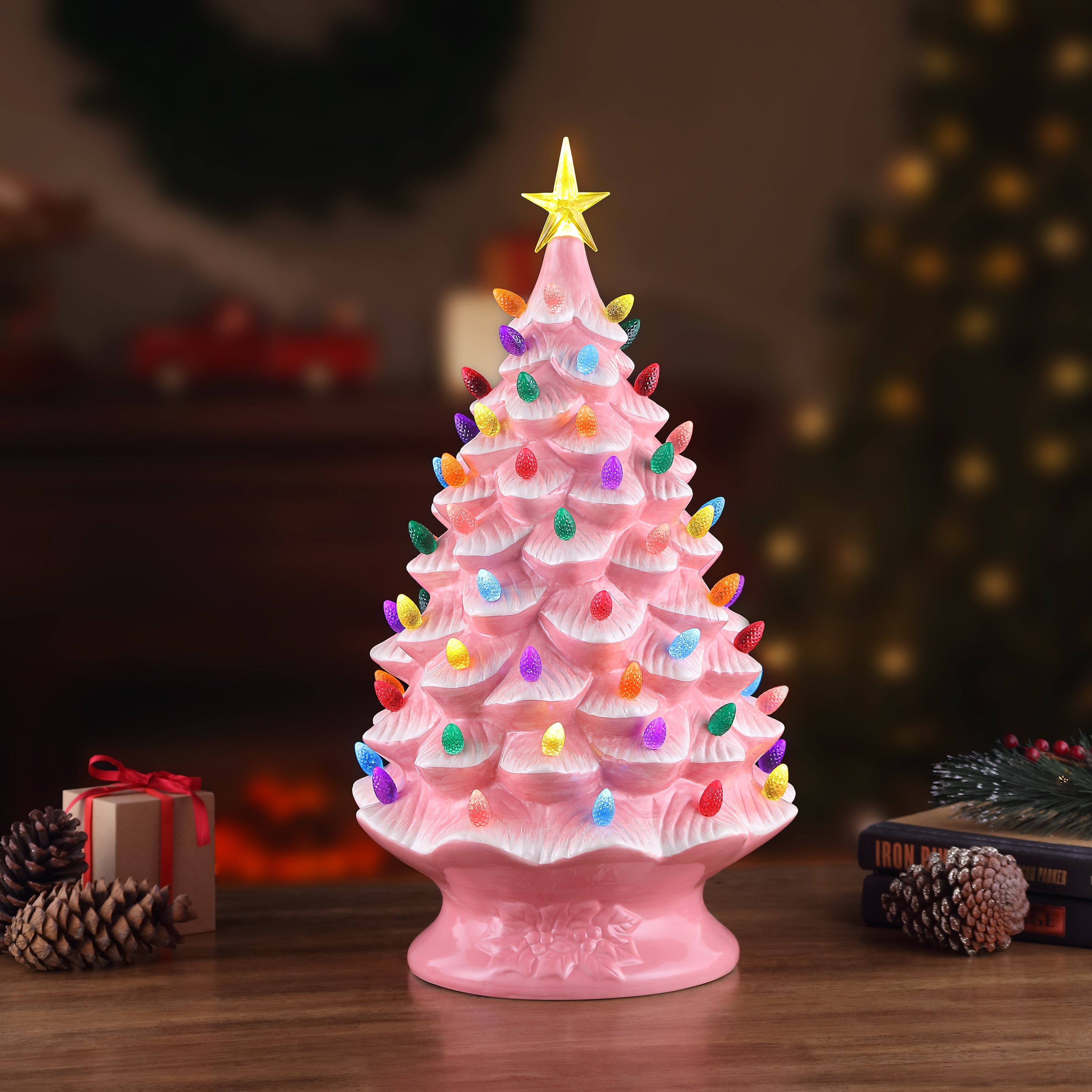 Pink nostalgic tree by Mr. Christmas glowing on a tabletop with festive holiday decor