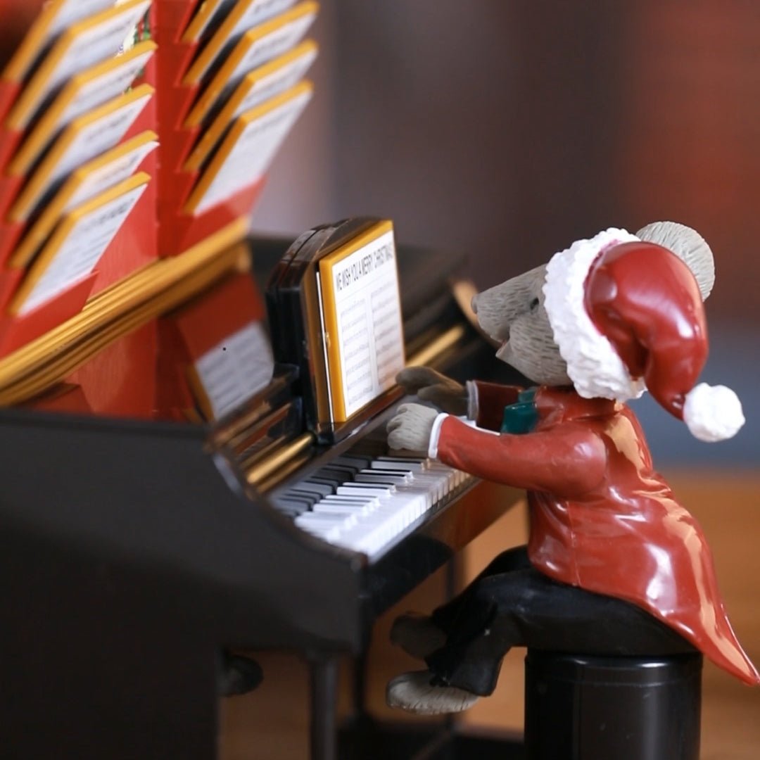 Side close-up view of Mr. Christmas Magical Maestro Mouse playing the piano.