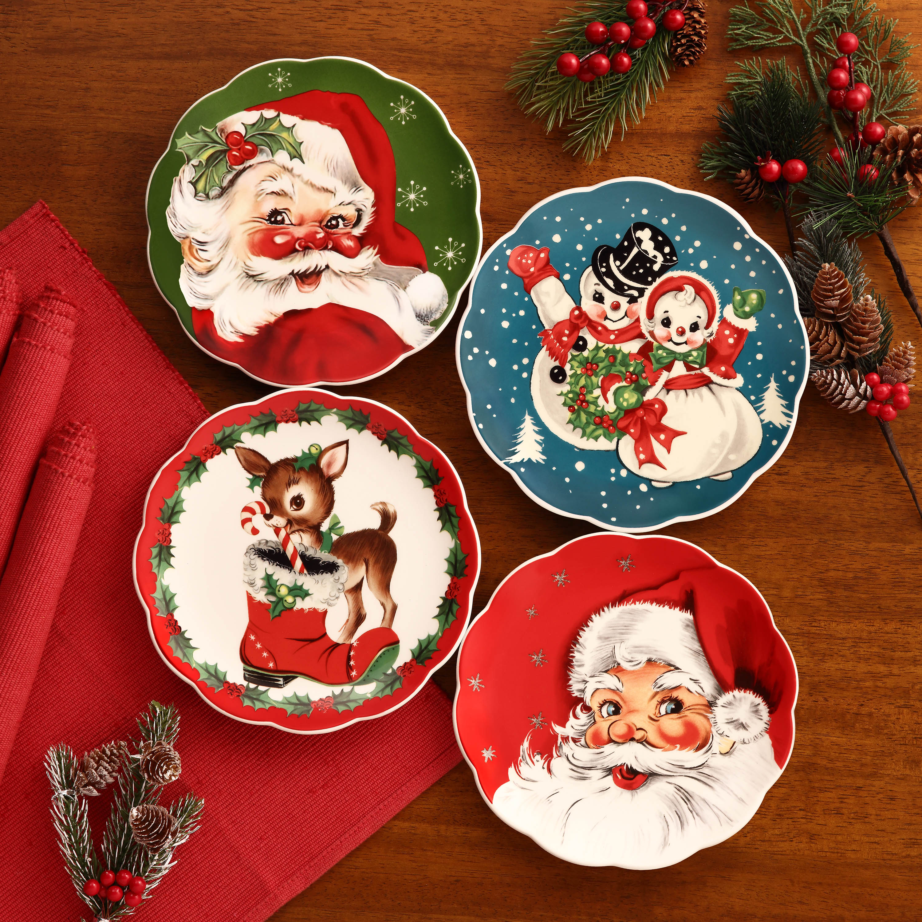 Mr. Christmas nostalgic scalloped plates set on a festive table with red tablecloth and evergreen decor