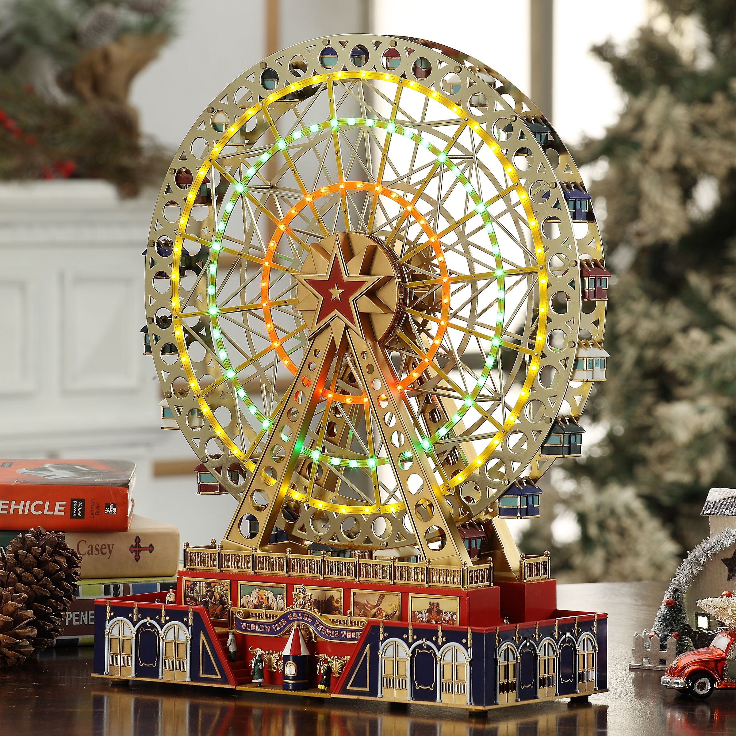 Mr. Christmas 15" Animated World's Fair Grand Ferris Wheel displayed on a tabletop with other festive decor in a home decorated for Christmas