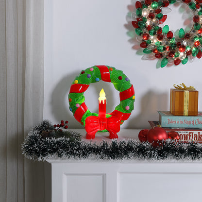 Decorative Christmas in. Lit Blow Mold Wreath with candle on a mantel, wreath and decorations in the background