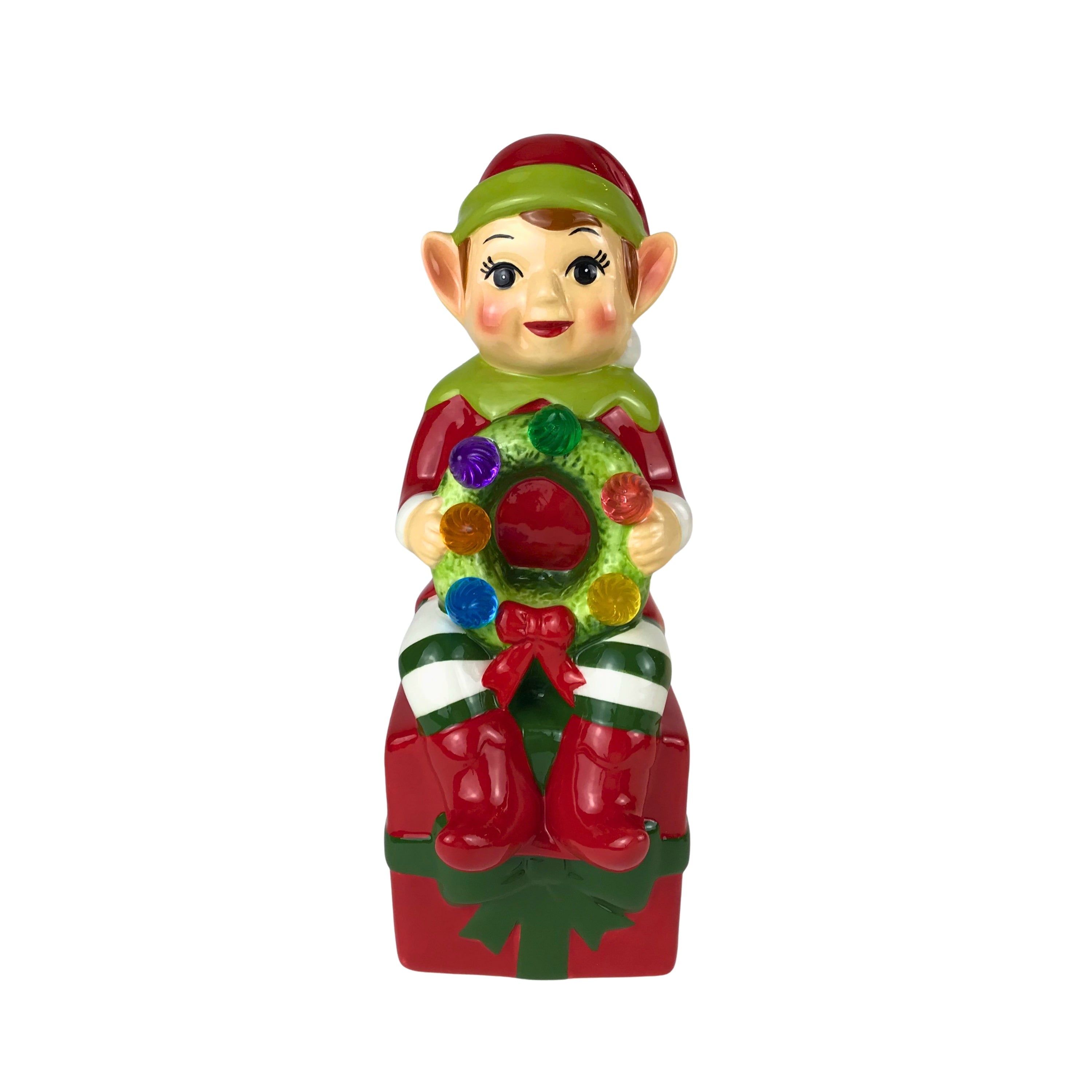 Colorful elf figurine holding a wreath on a white background