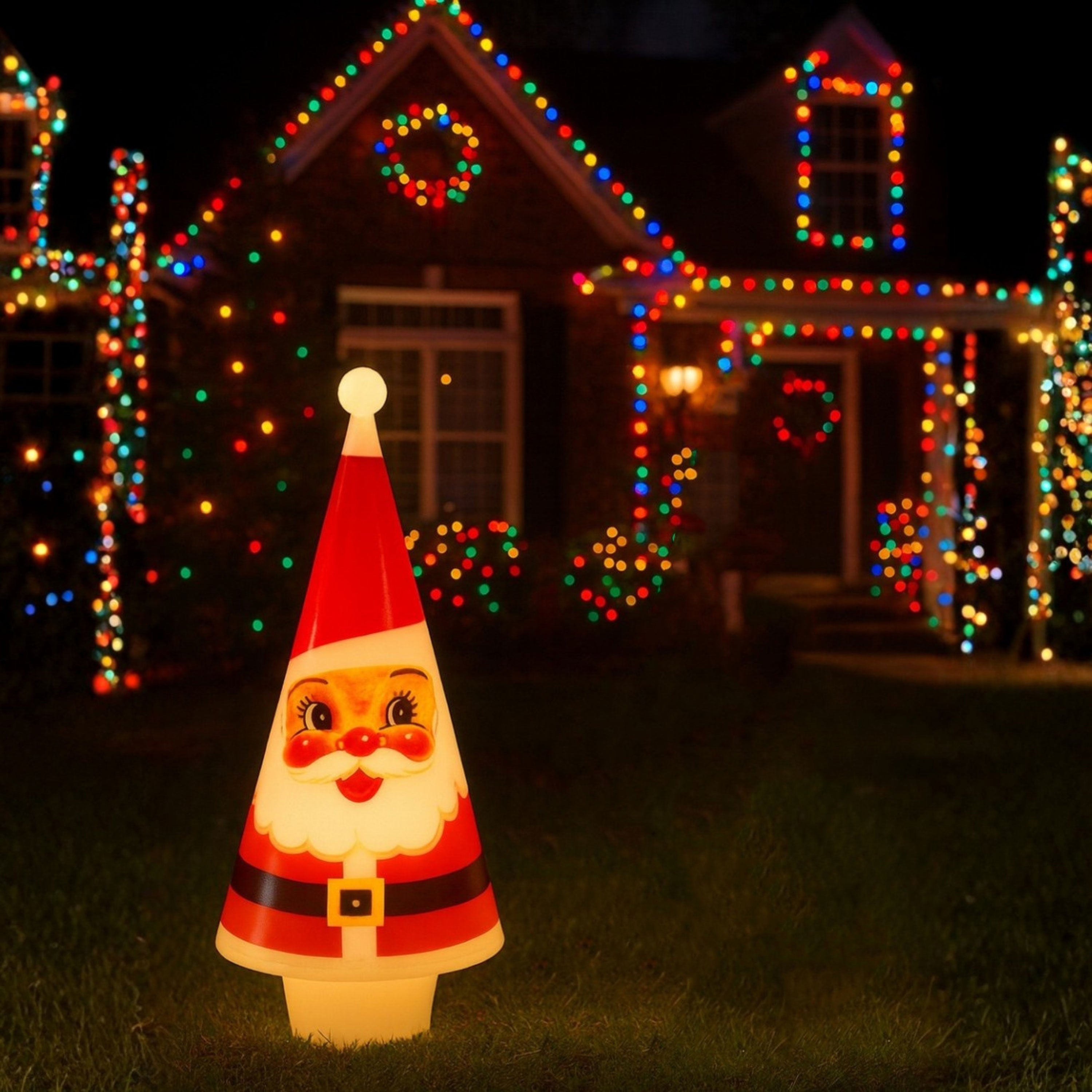Decorative Lit Nostalgic Blow Mold Cone Santa in front of a house with Christmas lights