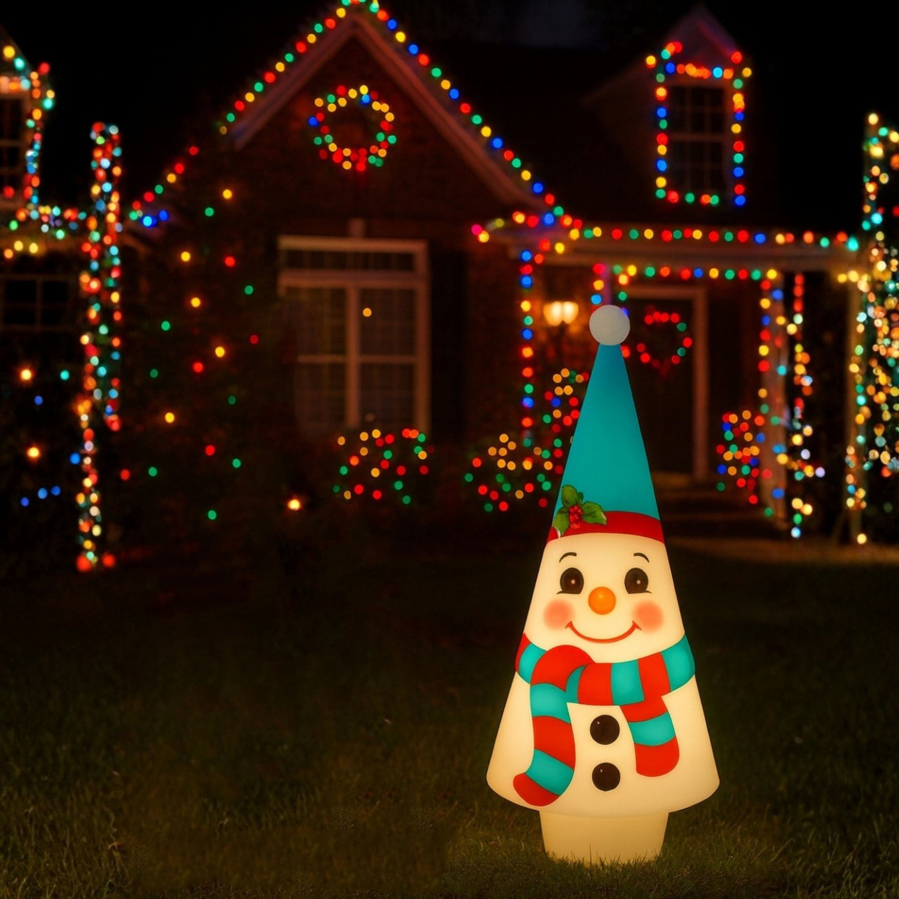 Lit Nostalgic Blow Mold Cone Snowman with colorful hat and scarf in front of a house with Christmas lights.