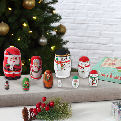 Set of Christmas-themed nesting dolls with a decorated tree in the background