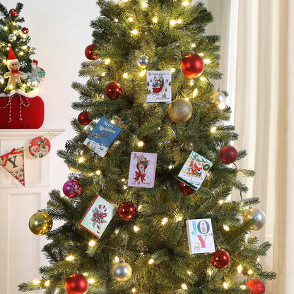 Decorated Christmas tree with lights, ornaments, and greeting cards in a festive setting.