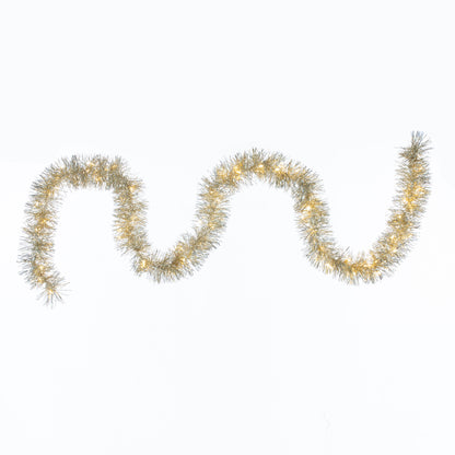 Three gold tinsel garlands on a white background