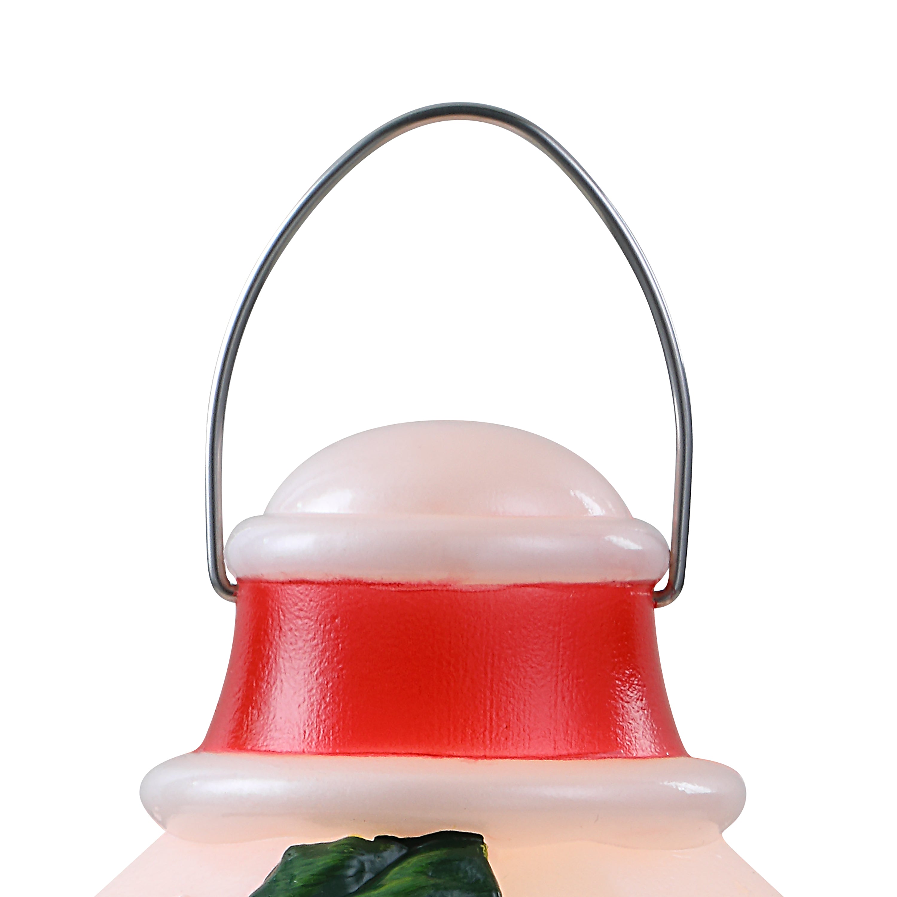 A close-up of a  lantern decoration featuring a red body, white trim, a metal handle, and a small green accent at the bottom, isolated on a white background.