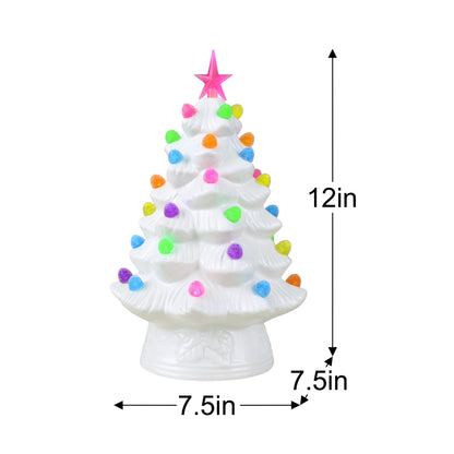 A small white Christmas tree figurine with a pink star on top and multicolored pom-pom ornaments, shown with dimension labels indicating 12 inches tall, 7.5 inches wide, and 7.