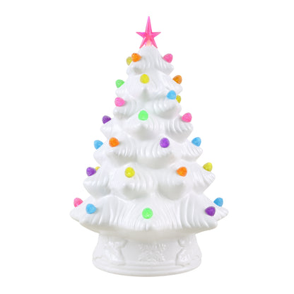 A white ceramic Christmas tree figurine decorated with colorful, gumdrops and topped with a pink star, set against a plain white background.