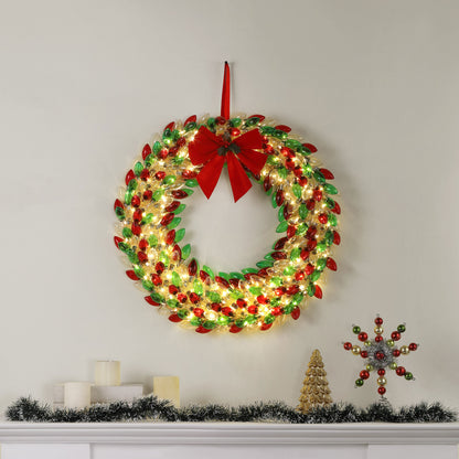 Mr. Christmas 30 in. Retro C9 Bulb Wreath with red and green colors hung on wall with festive decor on a mantel place