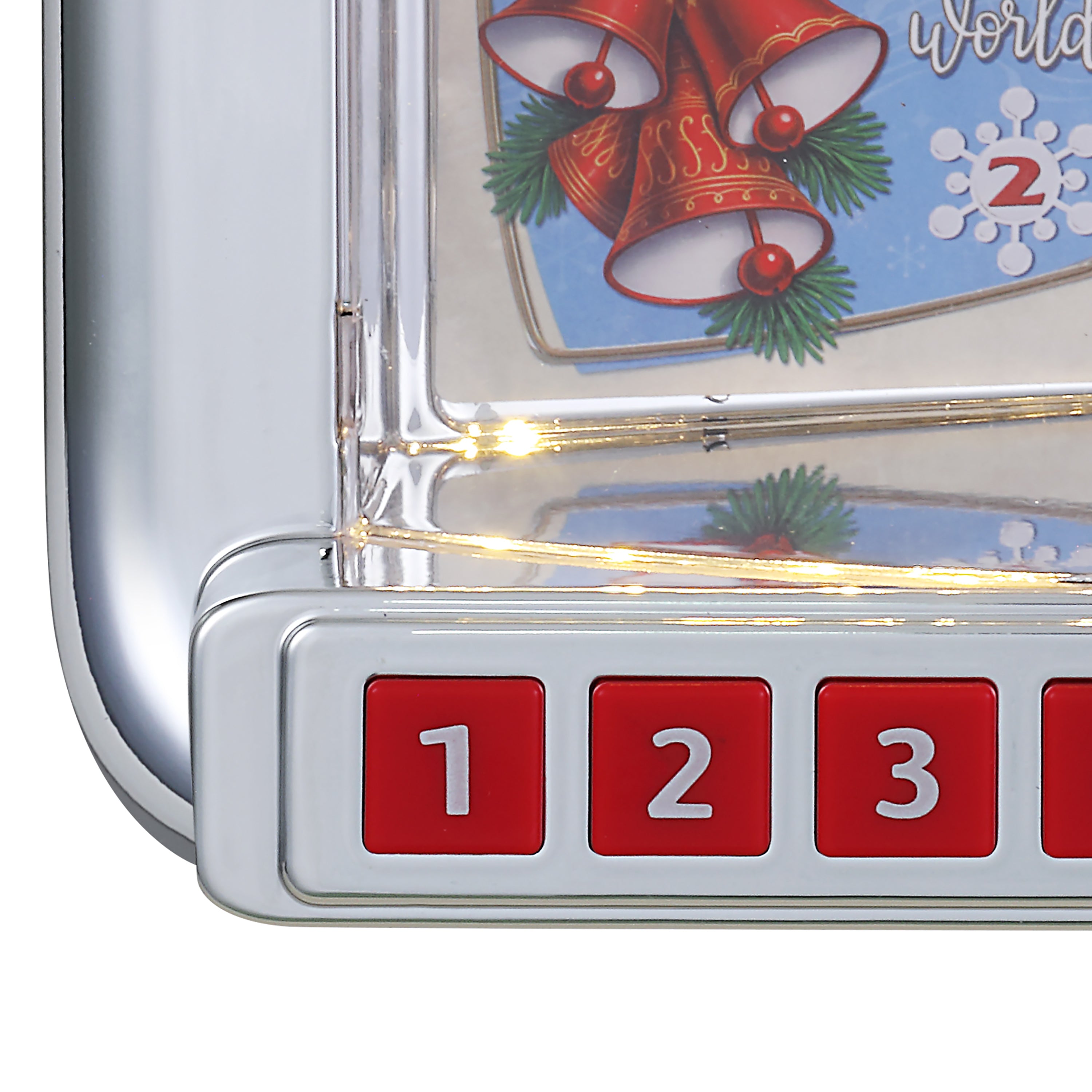 Close-up of Christmas Diner Jukebox with four red buttons labeled 1, 2, 3, and part of a 4, plus a festive Christmas bell graphic on the display.
