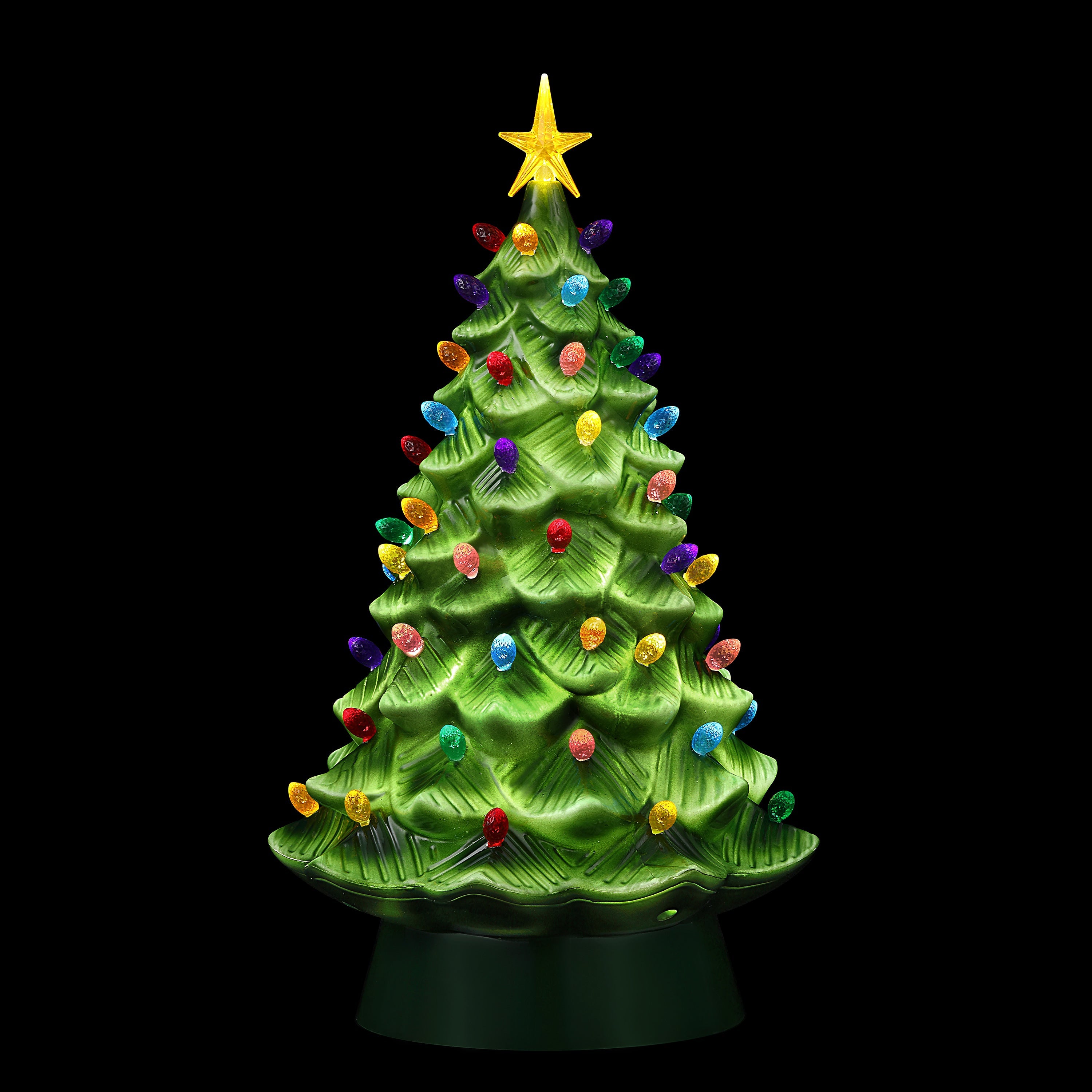 Lit 24-inch nostalgic green tree glowing with multicolored bulbs and star against a black background
