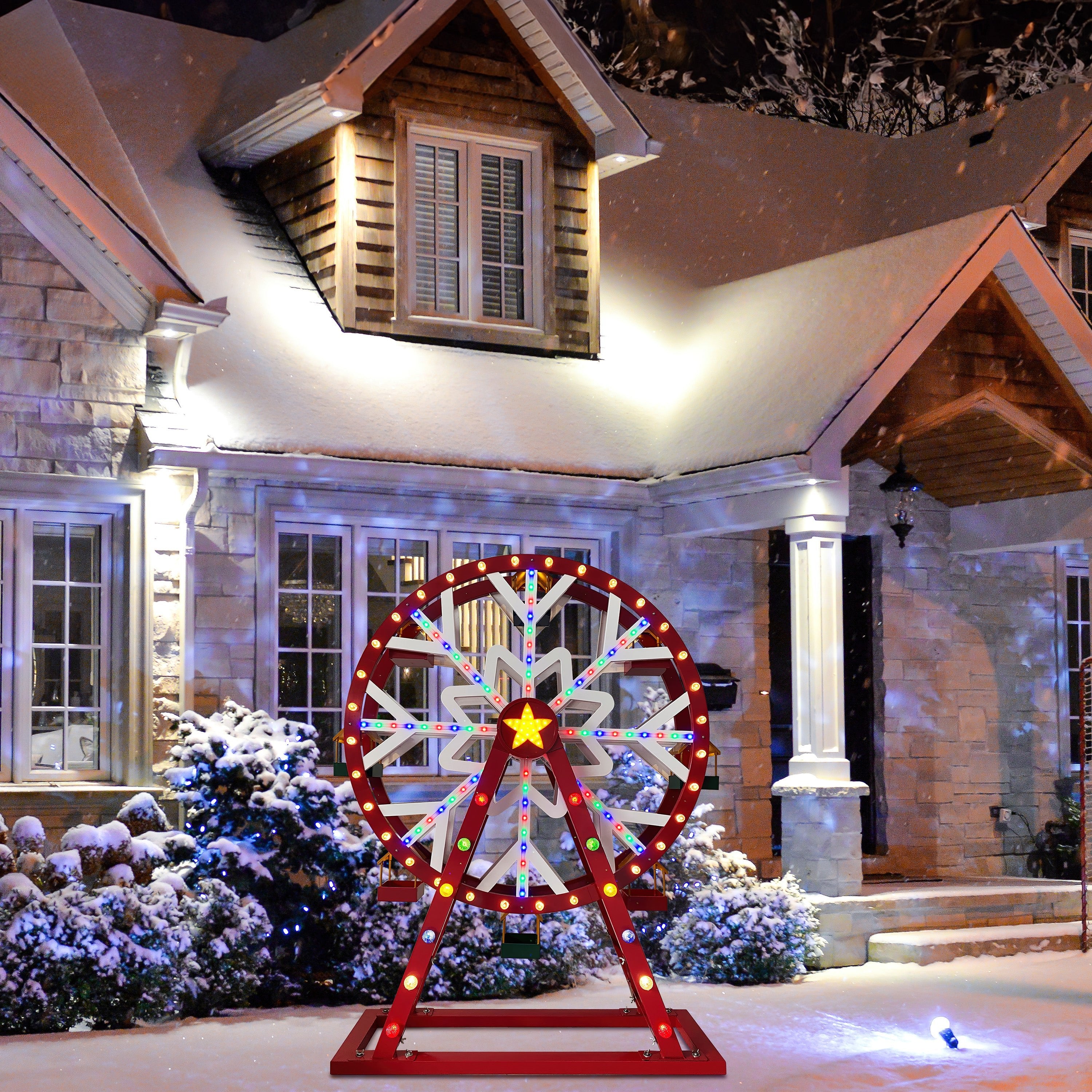 Mr. Christmas Oversized Animated Ferris Wheel displayed outdoors near a snow-covered house with festive lights