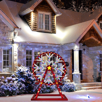 Mr. Christmas Oversized Animated Ferris Wheel displayed outdoors near a snow-covered house with festive lights