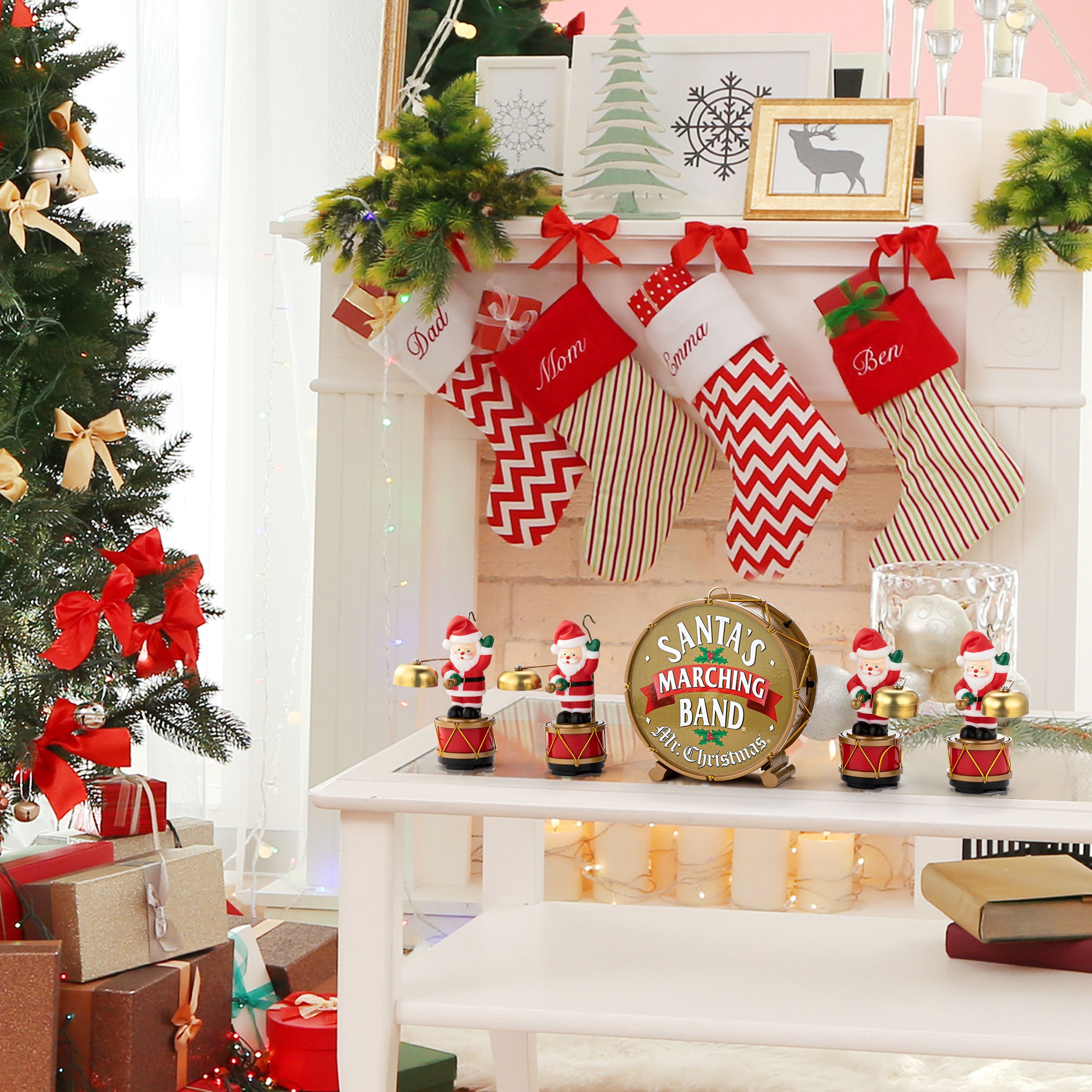Mr. Christmas Animated Santa's Marching Band displayed on a holiday tabletop next a mantel with stockings and a Christmas tree