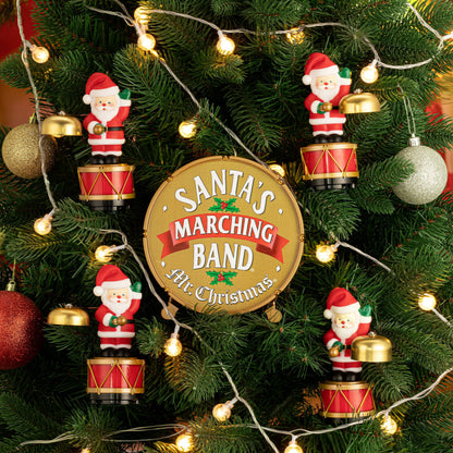 Close-up of Mr. Christmas Animated Santa's Marching Band hung as ornaments on a Christmas tree