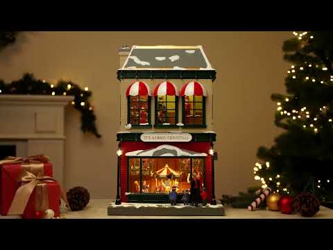 Load video: 21.5&quot; Animated &amp; Musical Vintage Department Store Video Overview  showing a rotating carousel and moving shoppers with classic Christmas music playing