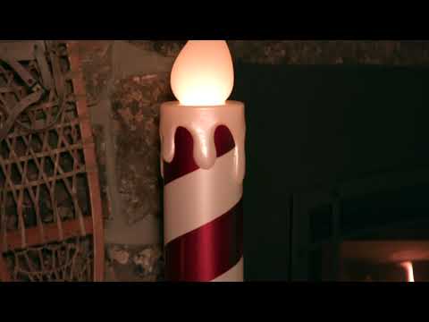 Load video: Video of Mr. Christmas 36 in. Striped Metallic Blow Mold Candle - Red and Green with flickering LED flame