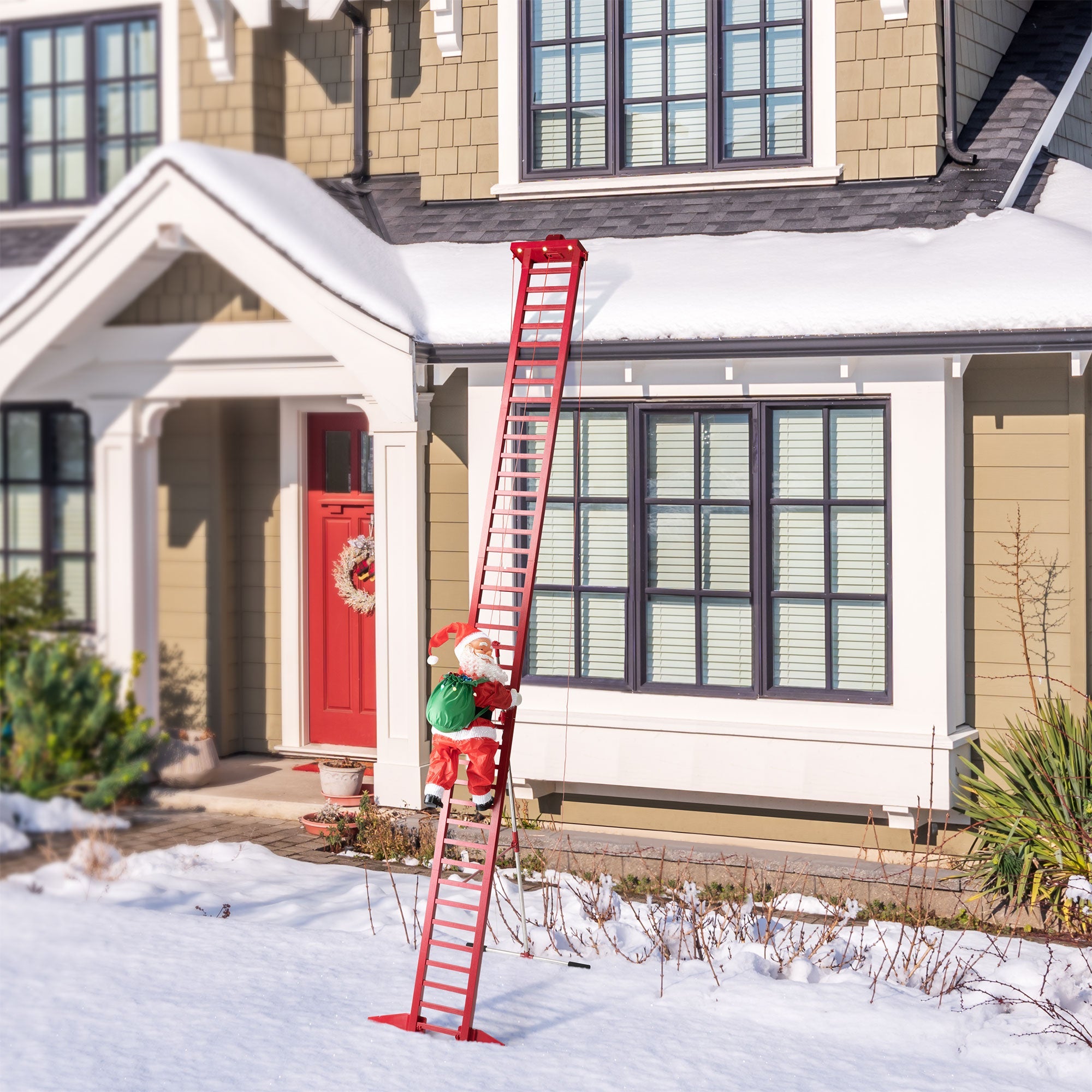 Mr. Christmas 10' Outdoor Animated Super Climbing Santa displayed against a house with snow on the ground and roof