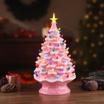 Pink nostalgic tree by Mr. Christmas glowing on a tabletop with festive holiday decor