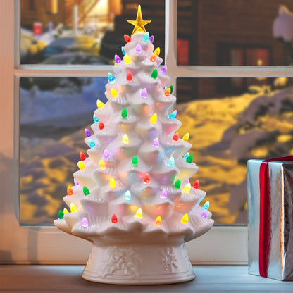 Close-up lifestyle image of the Mr. Christmas 18" Nostalgic Christmas Tree in white with glowing bulbs and star