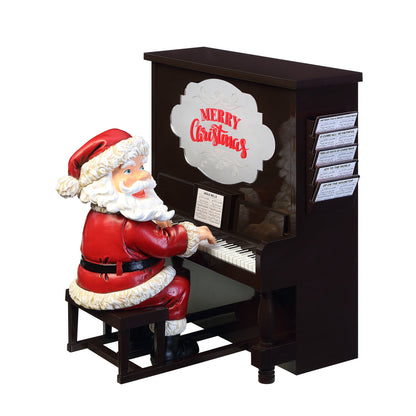  Main image of Mr. Christmas Sing-A-Long Santa with his head turned, seated at a black piano that says Merry Christmas with sheet music
